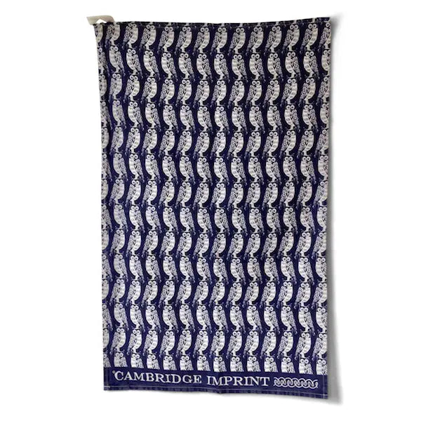 Navy blue towel with white pattern and 'Cambridge Imprint' branding on a white background