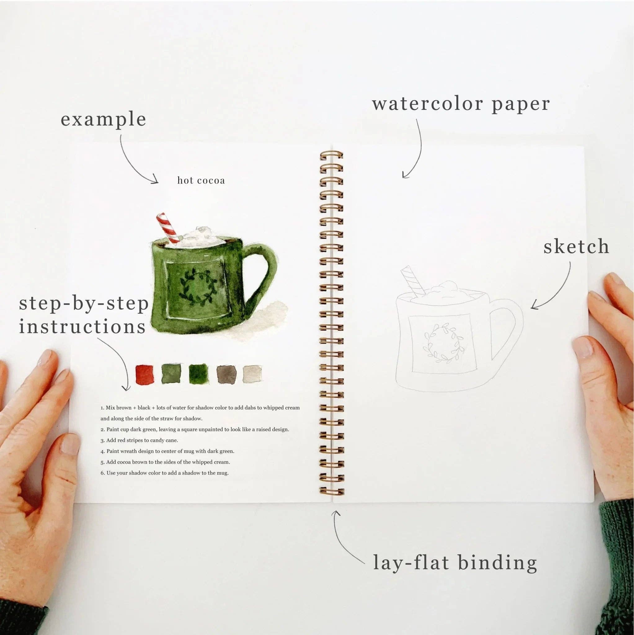 A sample page from the Christmas Watercolor Workbook, featuring a mug of cocoa and simple painting instructions.