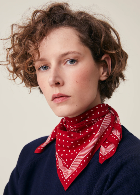 Model wearing the Allegra N'843 Moismont Scarf in Theater red as a neckerchief.