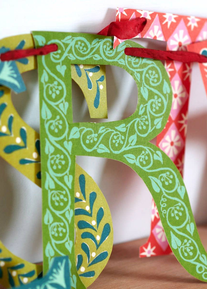 A close up photo of the Merry Christmas banner showing the unique design details on each letter