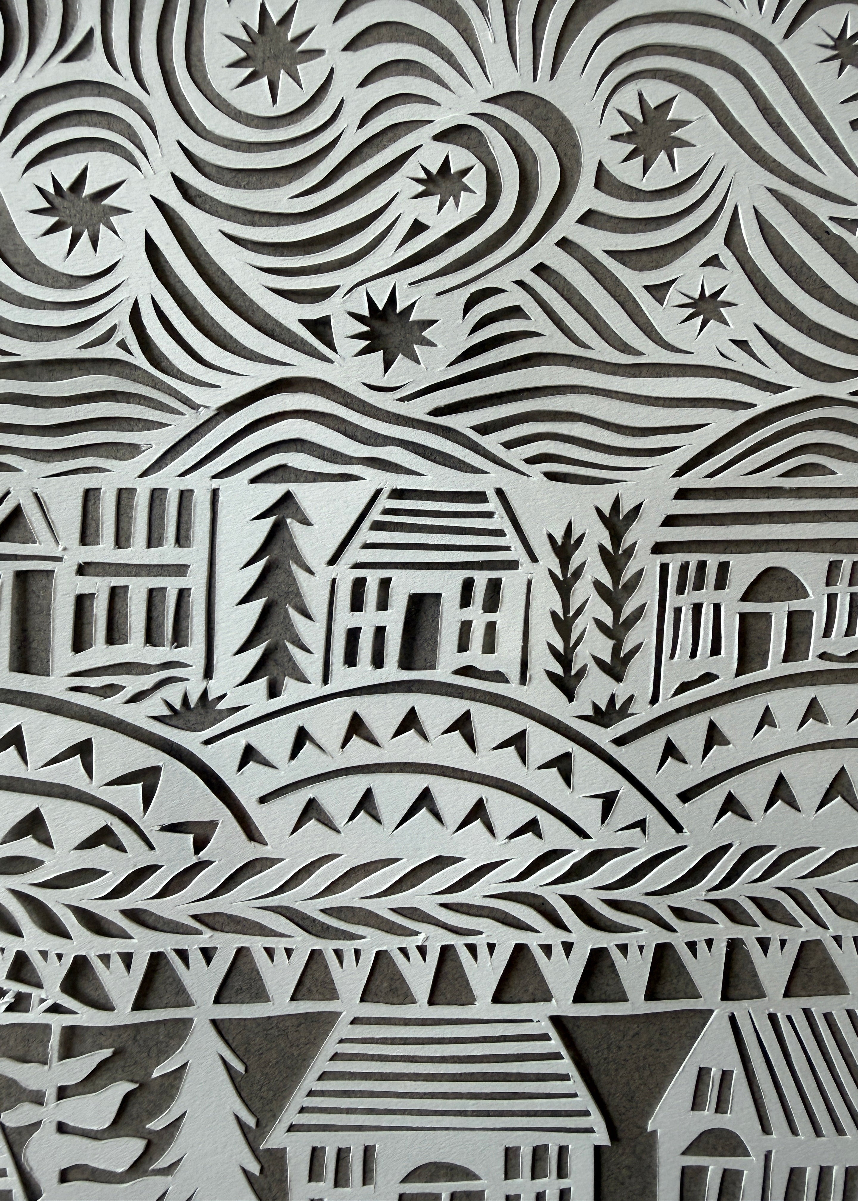 Close-up of Jennifer Judd-McGee's original "What Connects Us" papercut, highlighting the intricate hand-cut details and layered archival paper.
