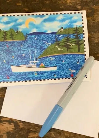 One "Hauling Traps" card with a white envelope and blue sharpie on a wood desk.