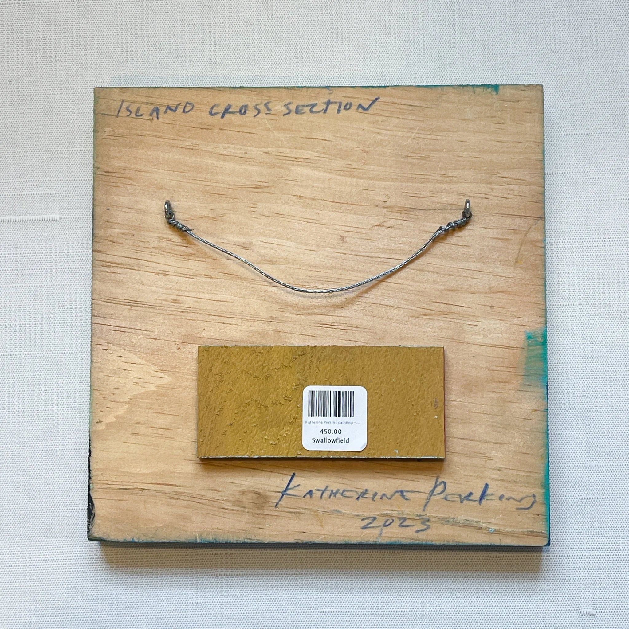 Wooden block with metal rod and label on a textured gray background