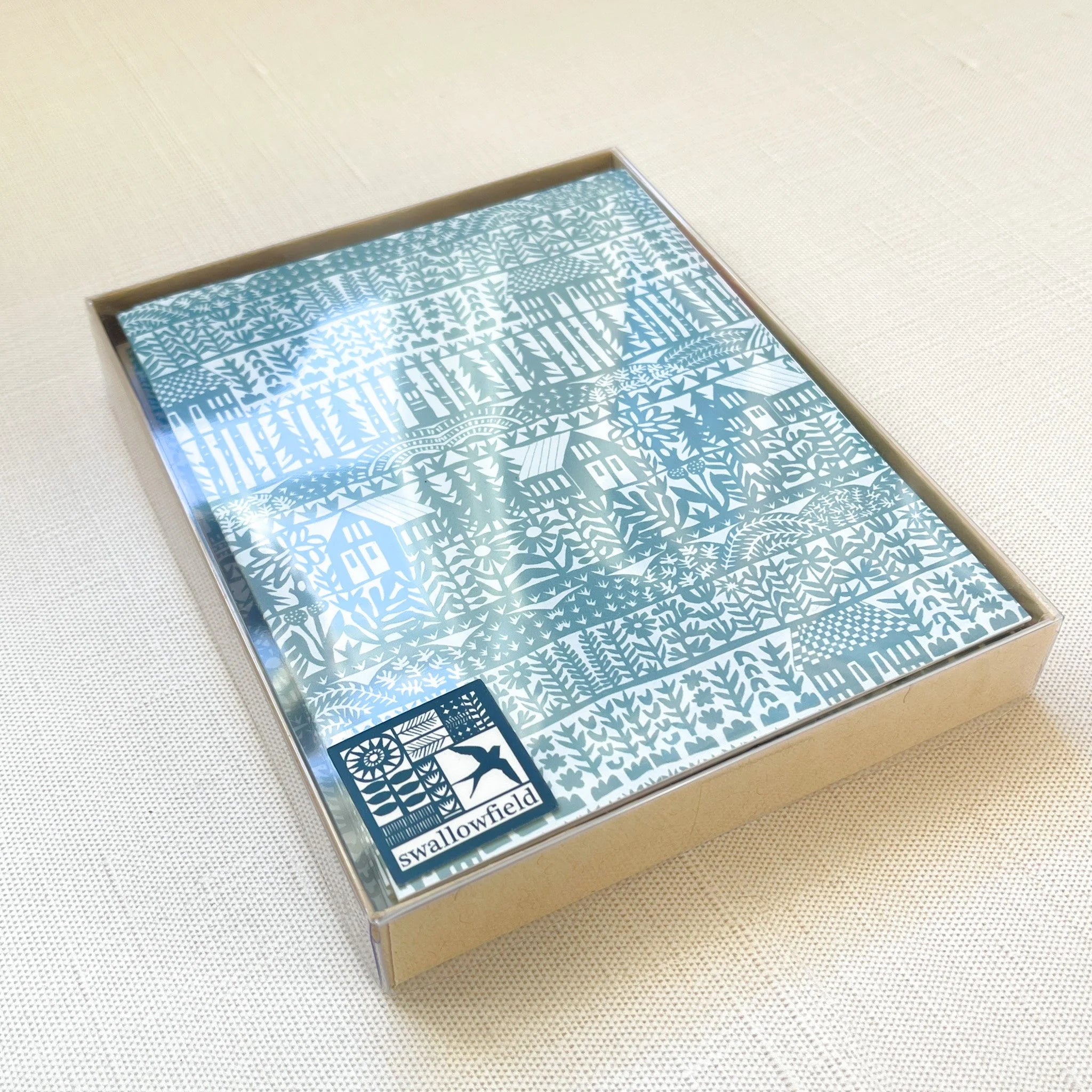 Packaged product with blue patterned design on a beige surface