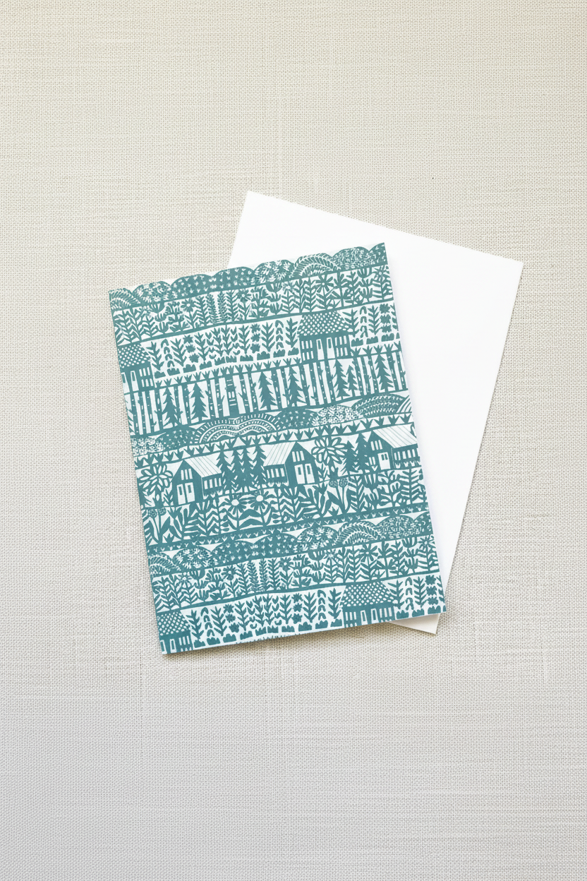Teal patterned card on a white envelope against a light gray background
