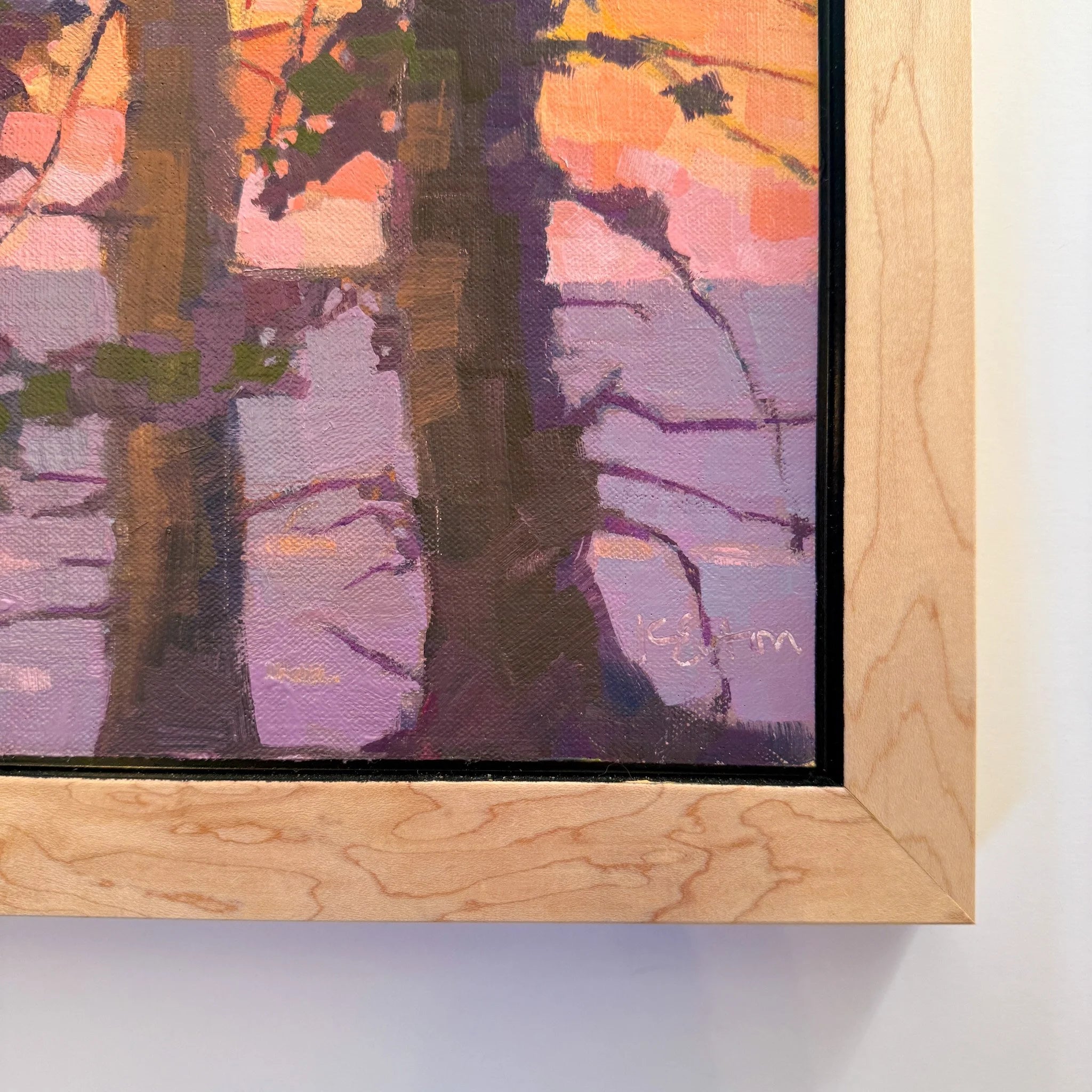 Framed artwork of trees with a colorful background