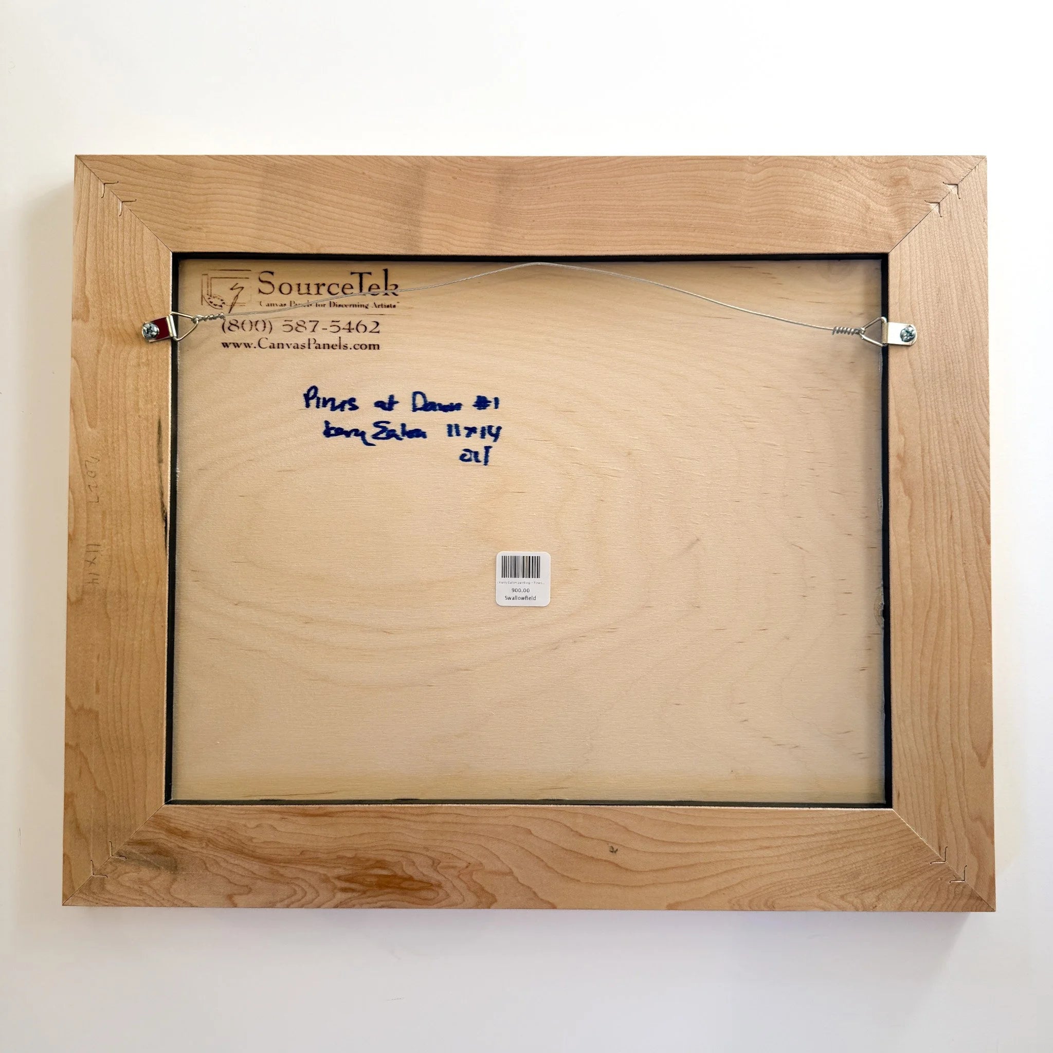 Back of a wooden picture frame with branding and text on a white background