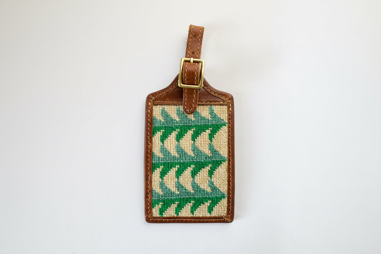 Luggage tag with green tree pattern on a white background