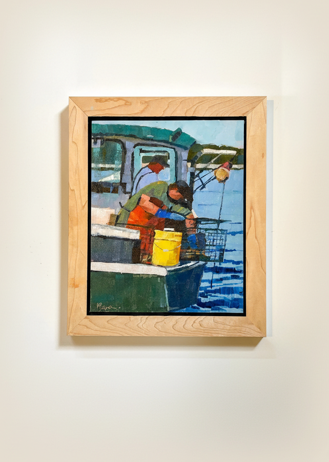 Framed painting of a scene with people and a boat on a wall.