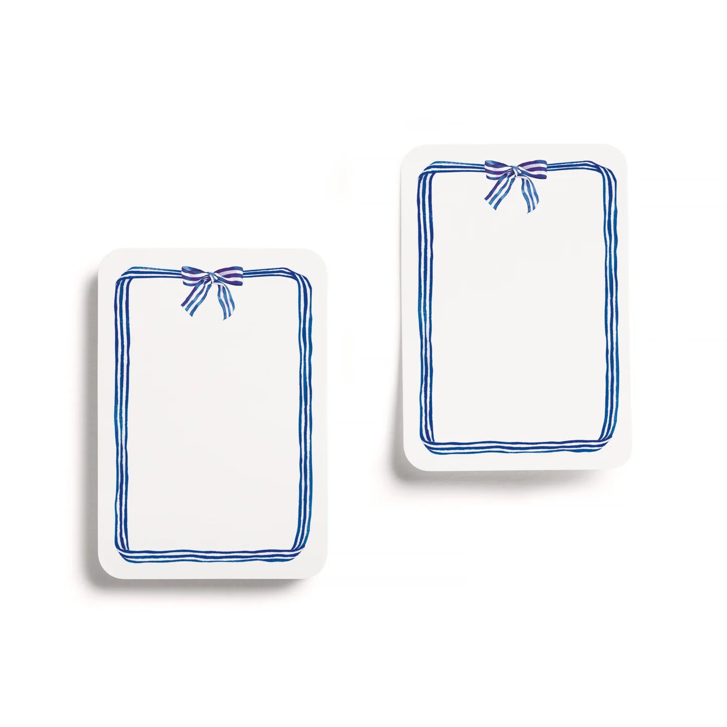 Two rectangular white plates with blue decorative bows on a white background