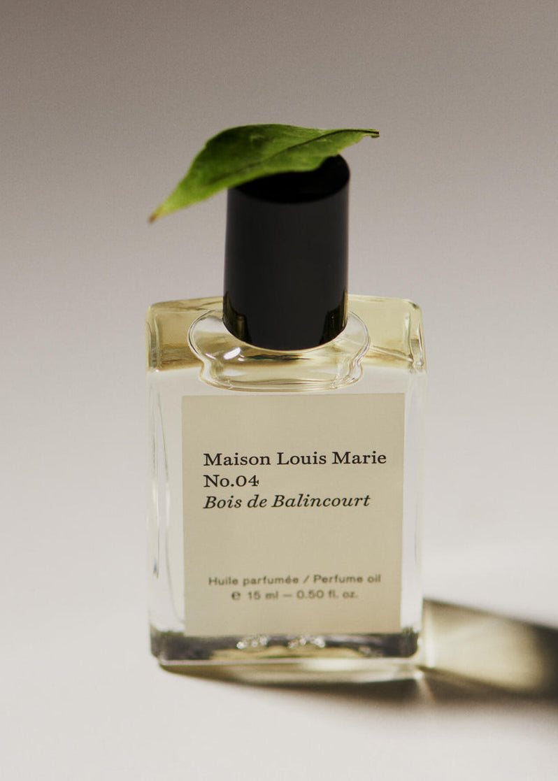No.04 Bois de Balincourt Perfume oil with a leaf balancing on top.
