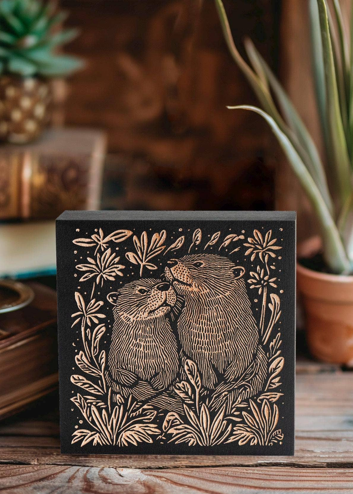 Otters, Engraved Birch Wood Panel sitting on a gardener's bench.
