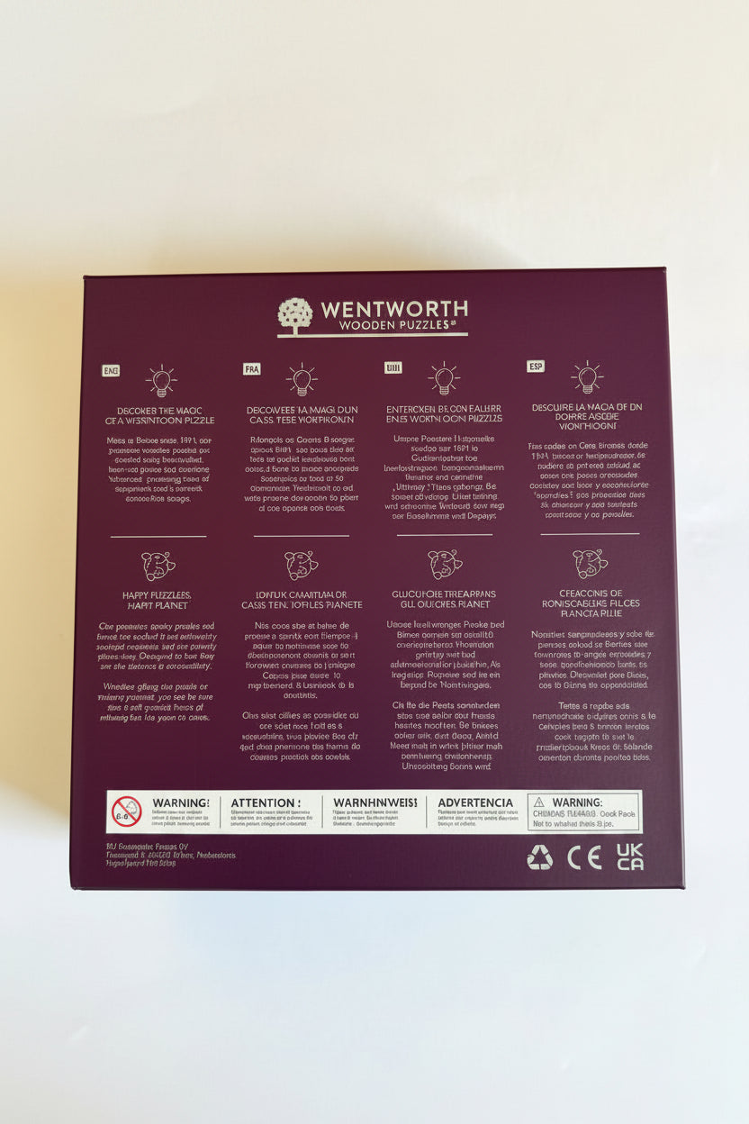 Photo of the back of the "Islesford Dock III" puzzle box with information about Wentworth puzzles in English, French, German, and Spanish.
