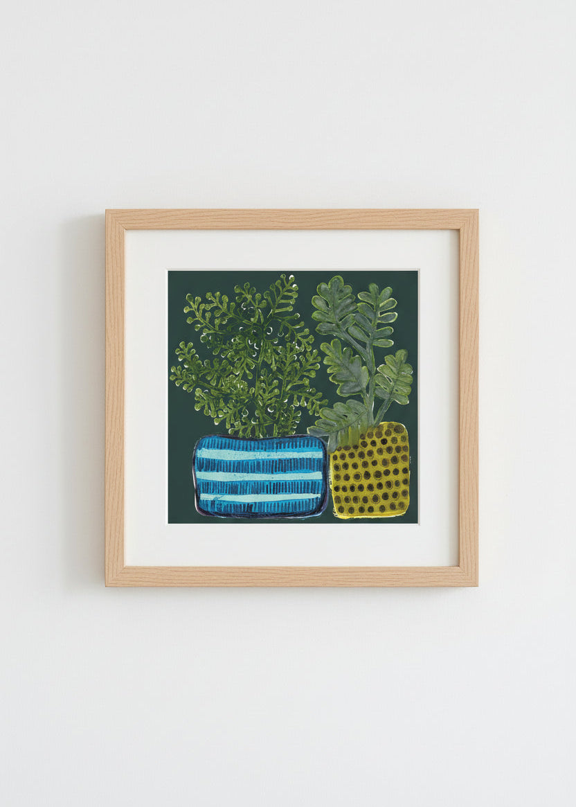 The "Plant Pots" archival print featuring plant pots with green foliage on a dark background with a white mat and light wood frame.