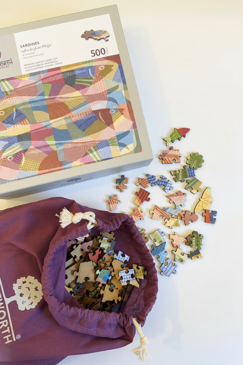 Photo of "Sardines" wooden pieces and puzzle box featuring artwork by Jennifer Judd-McGee.