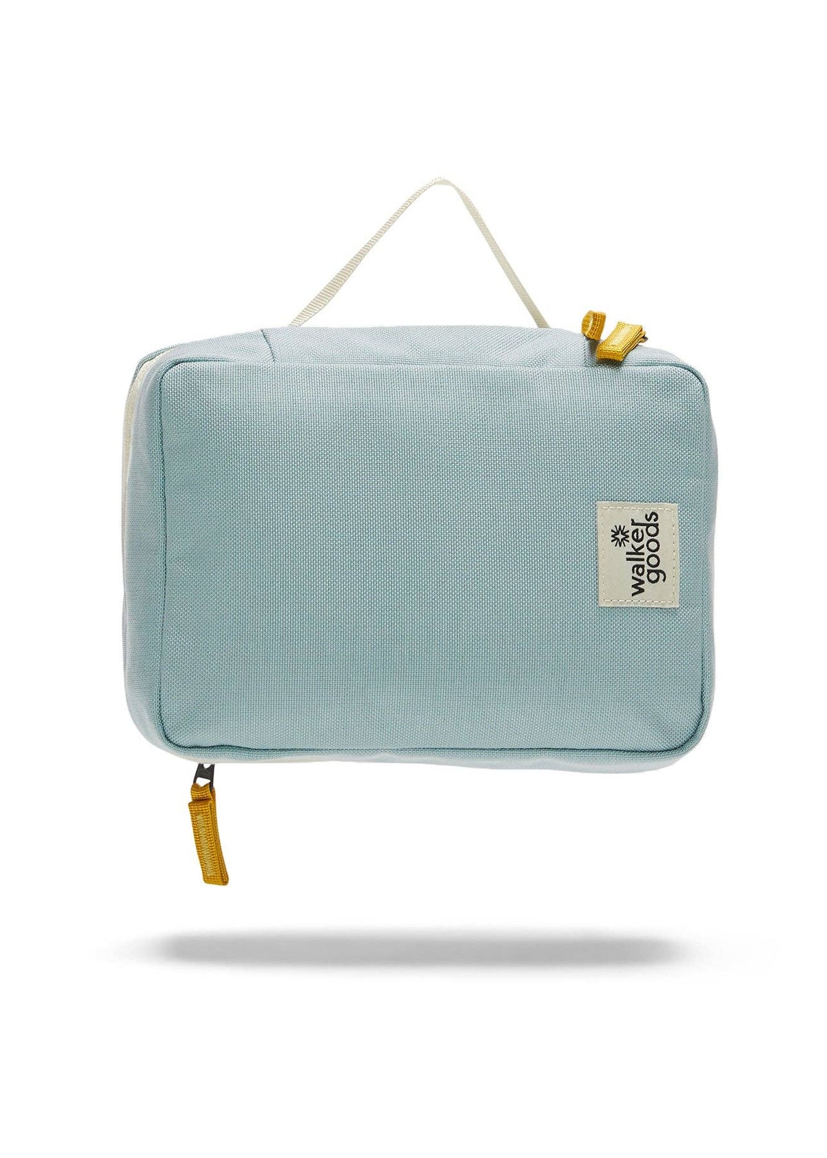 Rear view of the toiletry bag with top handle and company label.