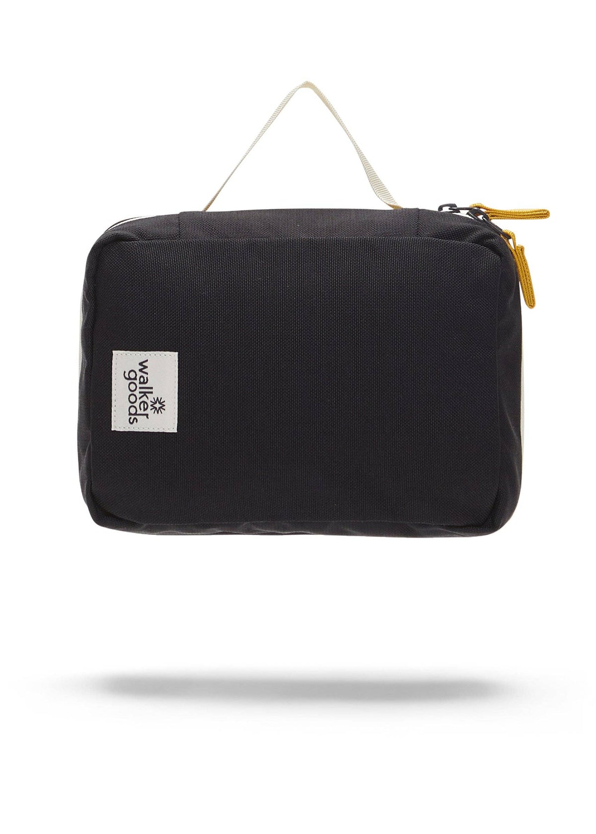 Rear view of the toiletry bag with top handle and company label.