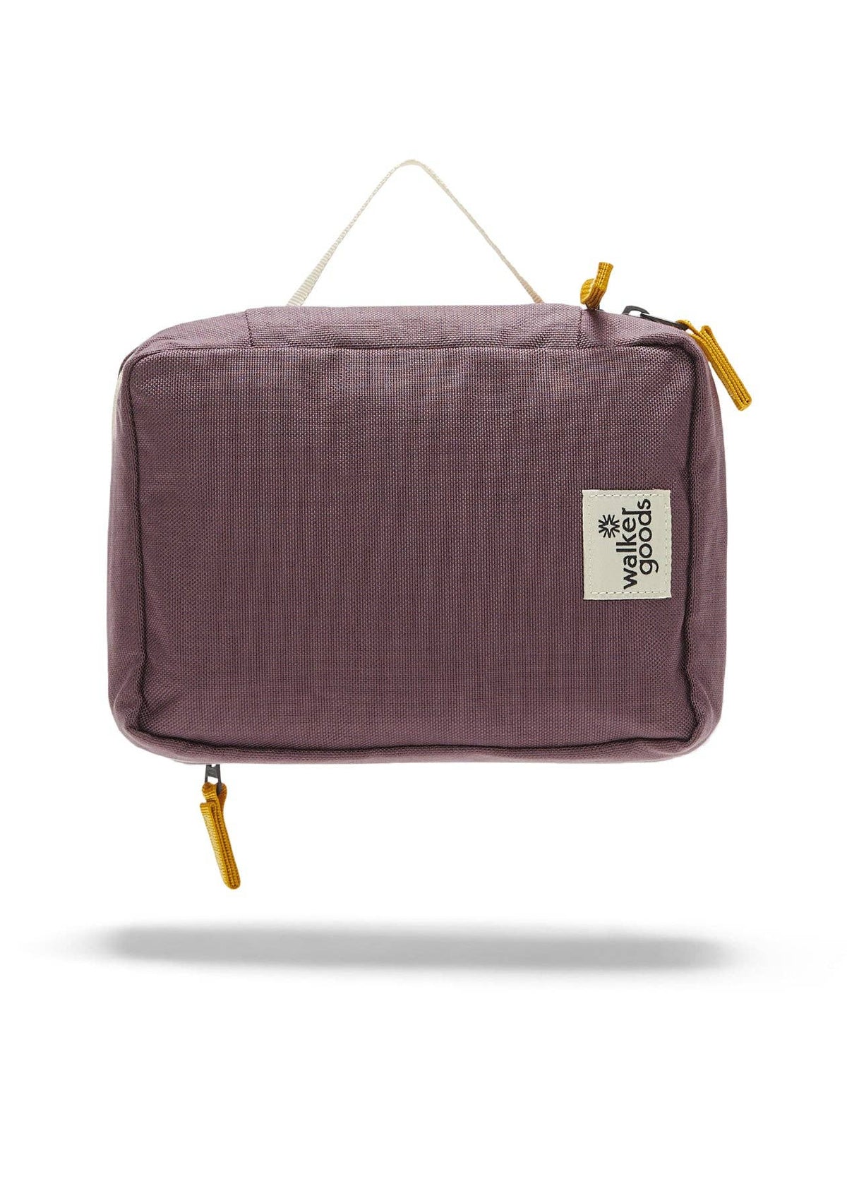 Rear view of the toiletry bag with top handle and company label.