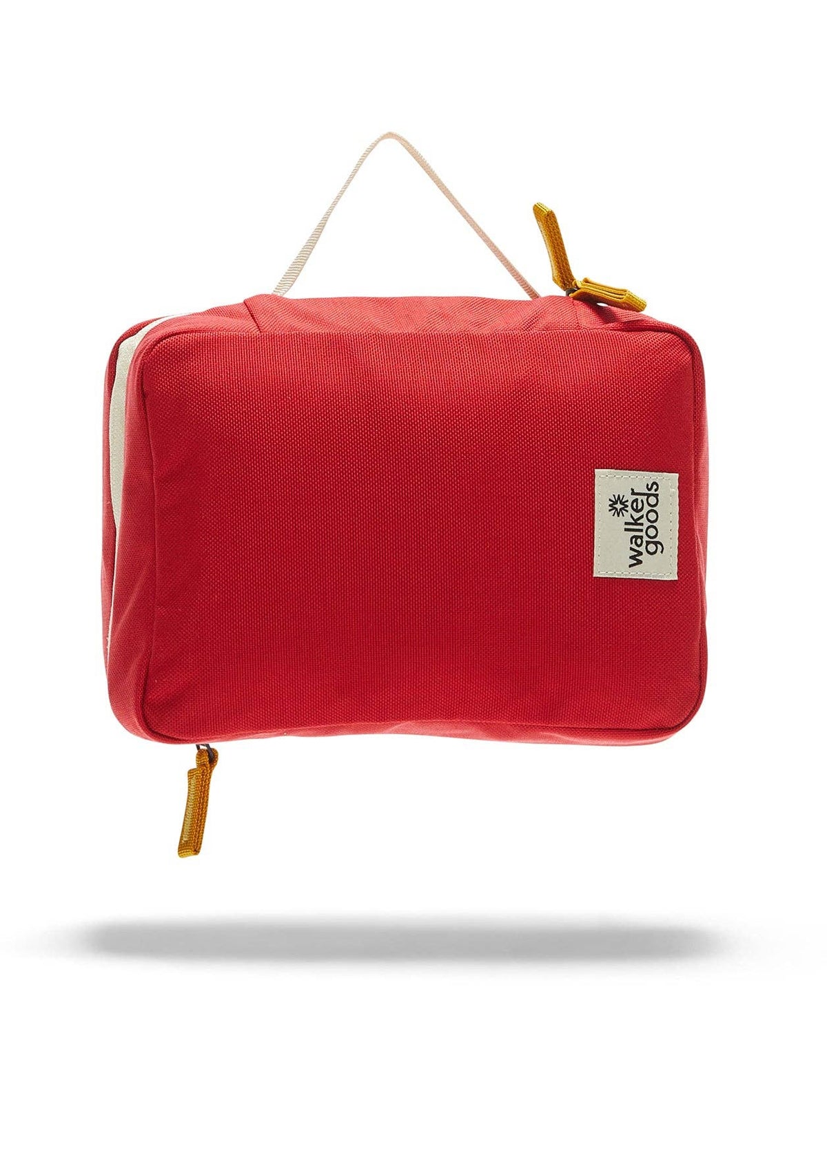 Rear view of the toiletry bag with top handle and company label.