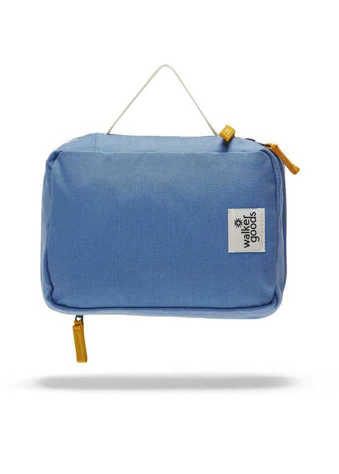 Rear view of the toiletry bag with top handle and company label.