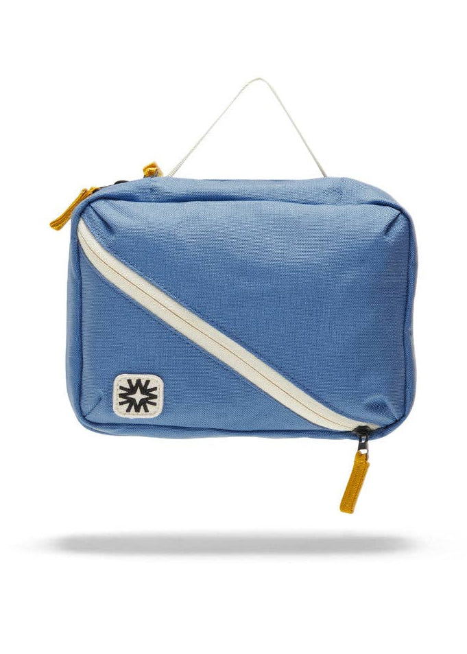 Front view of toiletry bag showing top handle, and front diagonal pocket.
