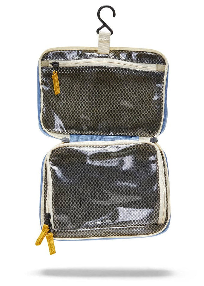 Interior photo of the Toiletry Bag  featuring clear mesh zipper pockets and a hook for hanging.