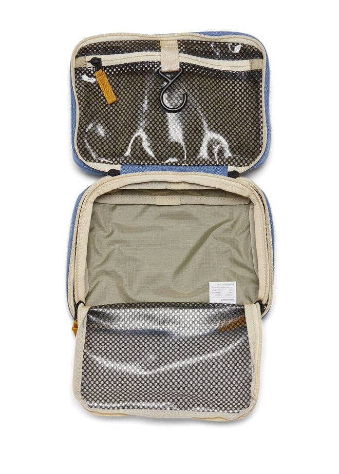 Interior photo of the Toiletry Bag featuring open clear mesh zipper pockets and a hook for hanging.
