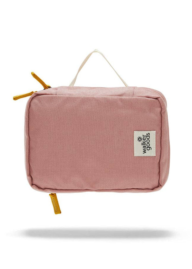 Rear view of the toiletry bag with top handle and company label.