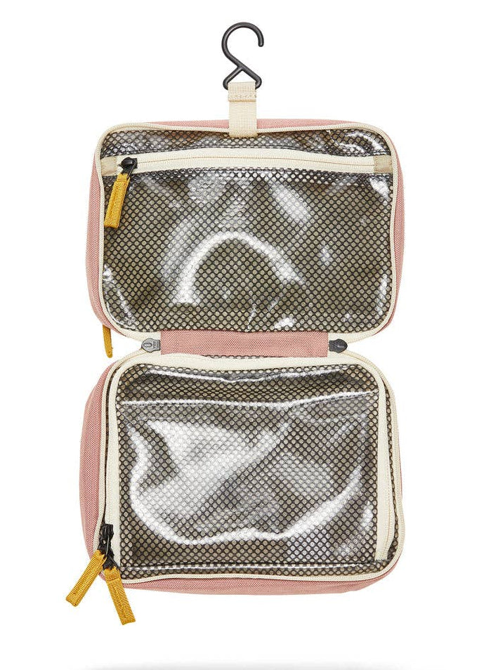 Interior photo of the Toiletry Bag  featuring clear mesh zipper pockets and a hook for hanging.