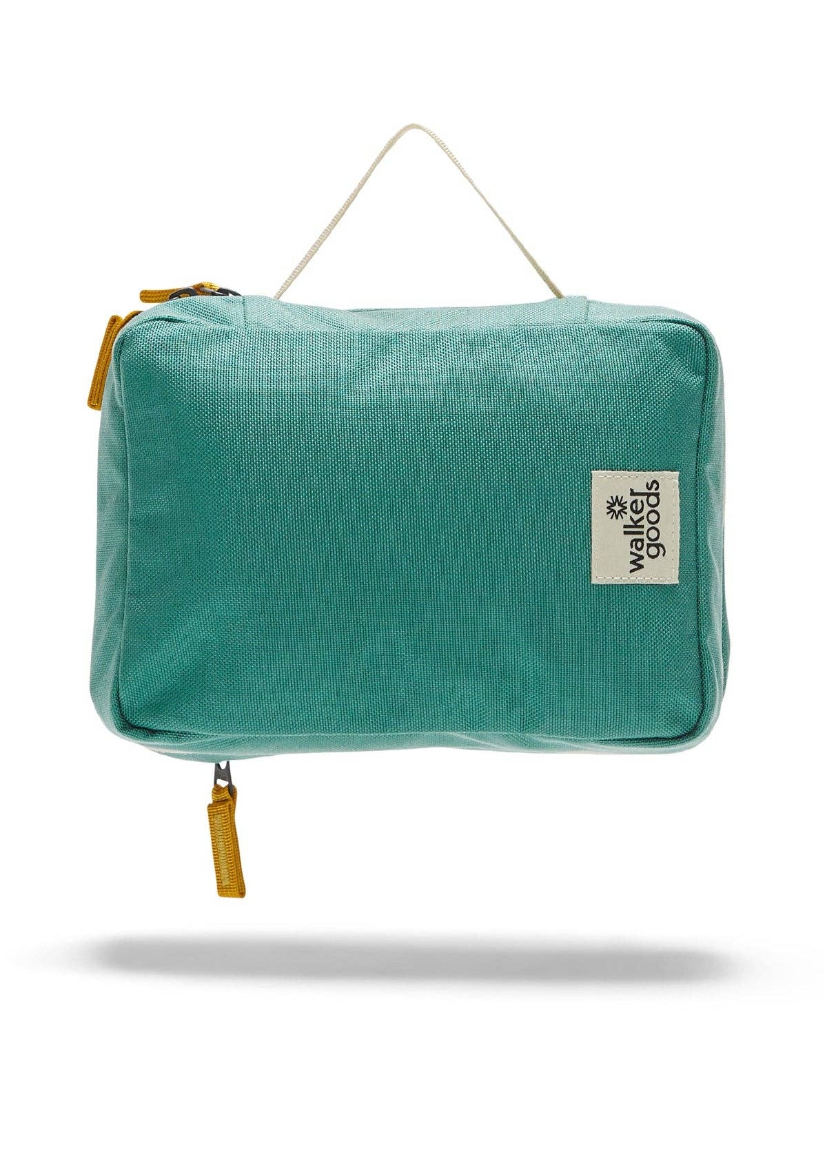 Rear view of the toiletry bag with top handle and company label.