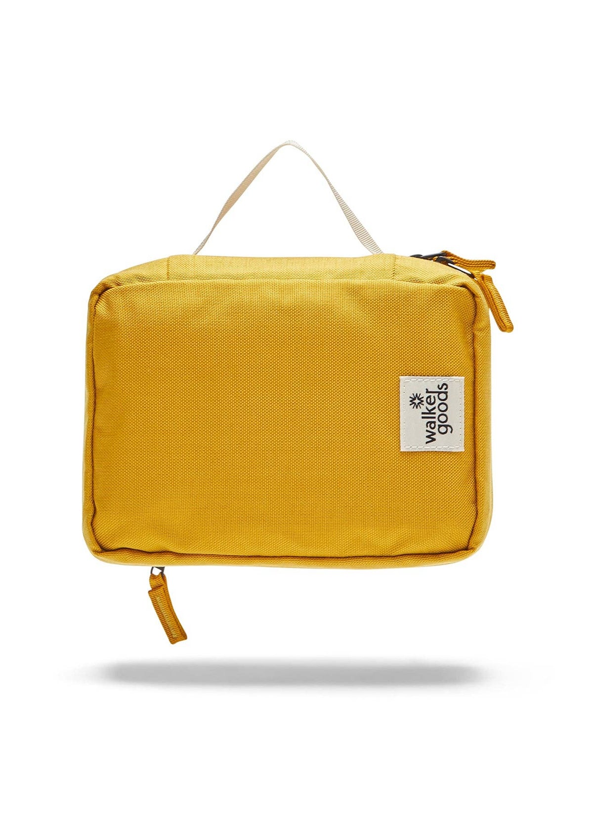 Rear view of the toiletry bag with top handle and company label.