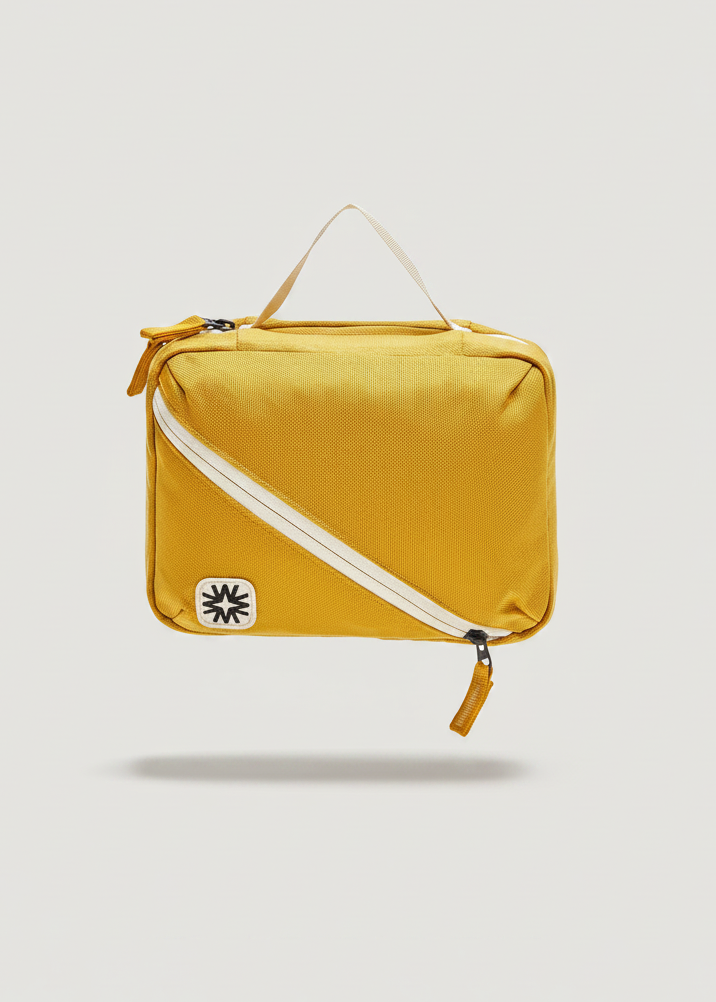 Front view of toiletry bag showing top handle, and front diagonal pocket.
