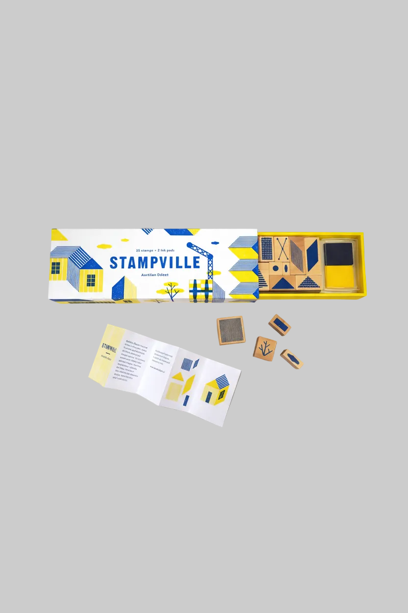 Stampville game box with wooden stamps on a gray background